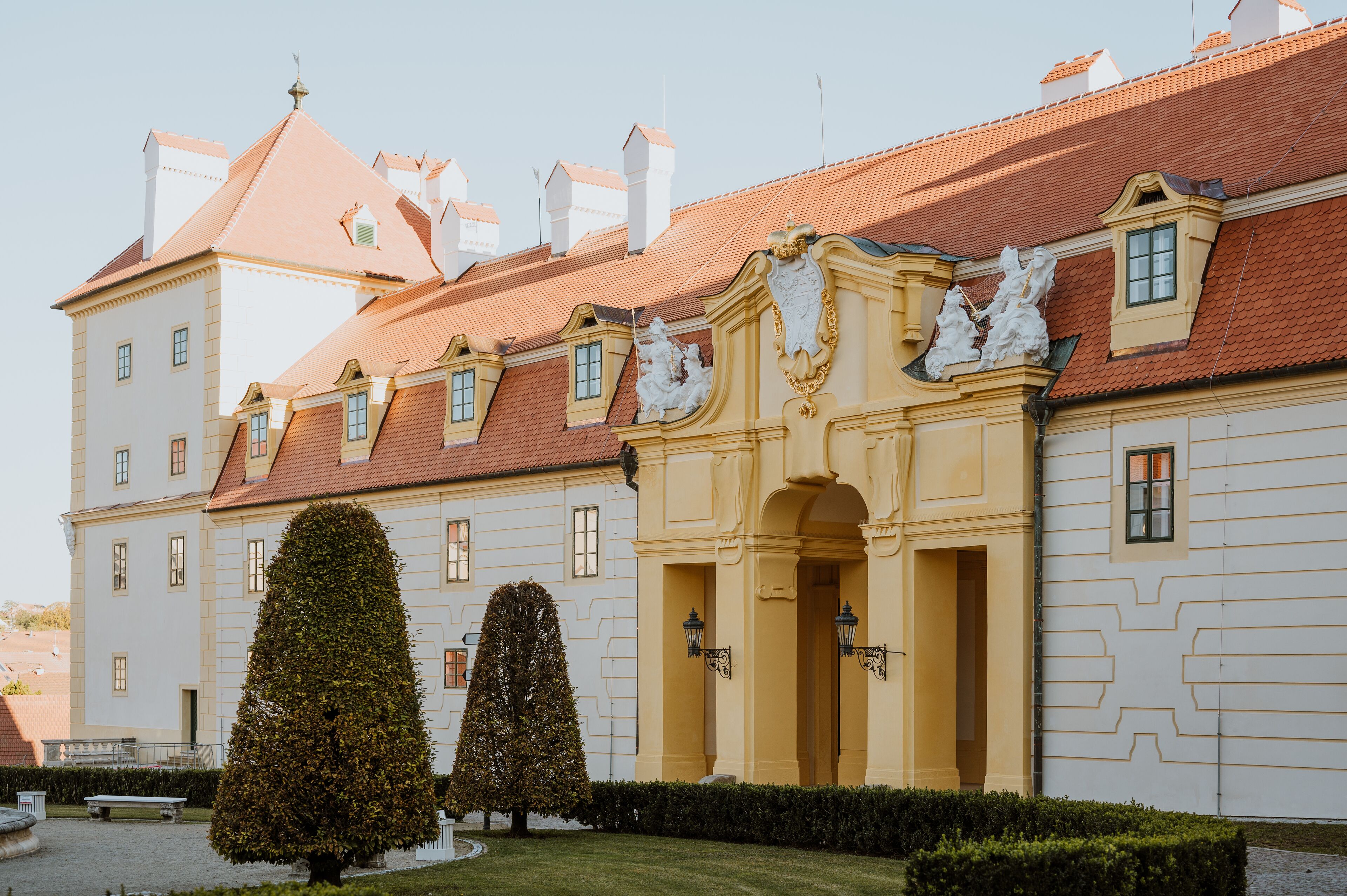 A historic building with a symmetrical facade, multiple windows, and a central entrance with decorative elements.
