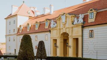 A historic building with a symmetrical facade, multiple windows, and a central entrance with decorative elements.