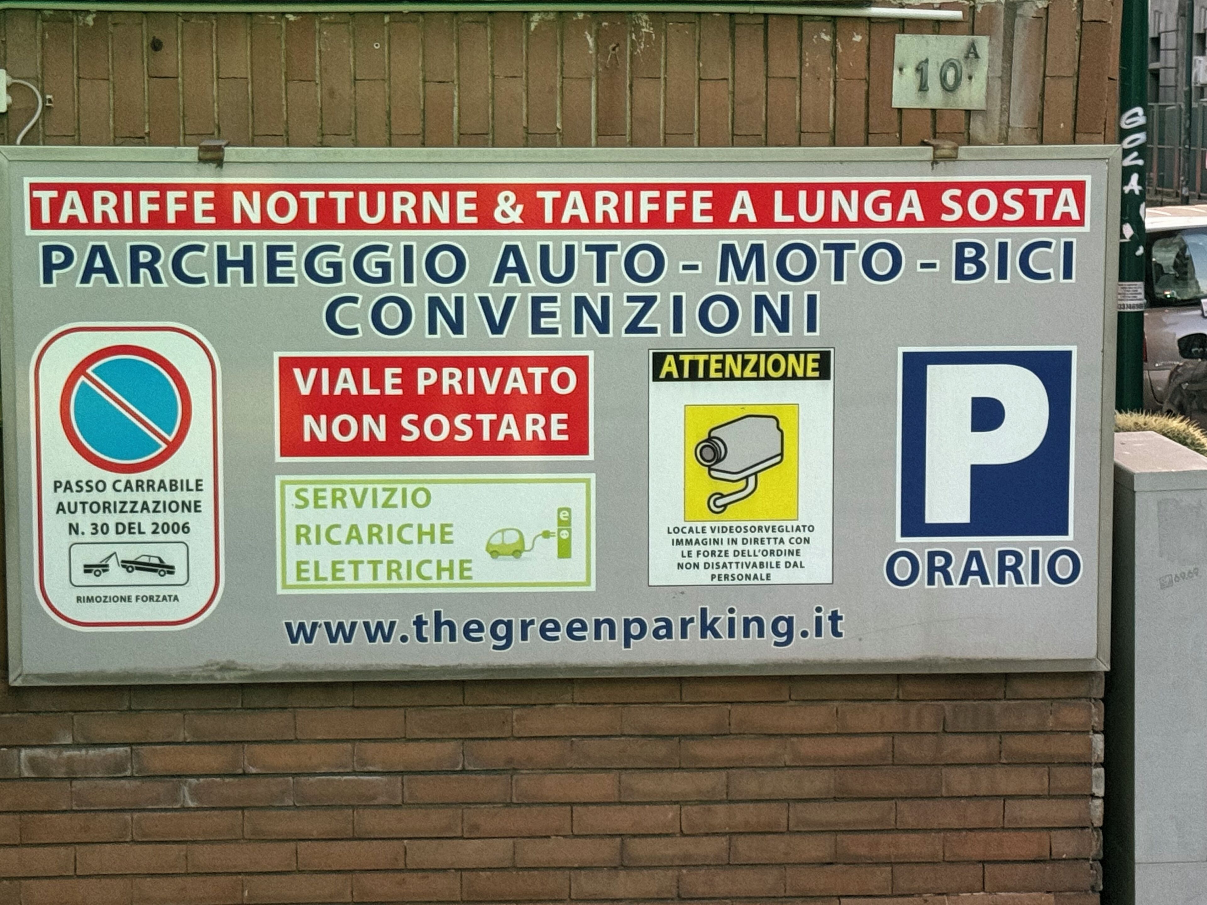 A parking sign with multiple sections including a no parking zone, private access, electric vehicle charging, surveillance, and a parking symbol.