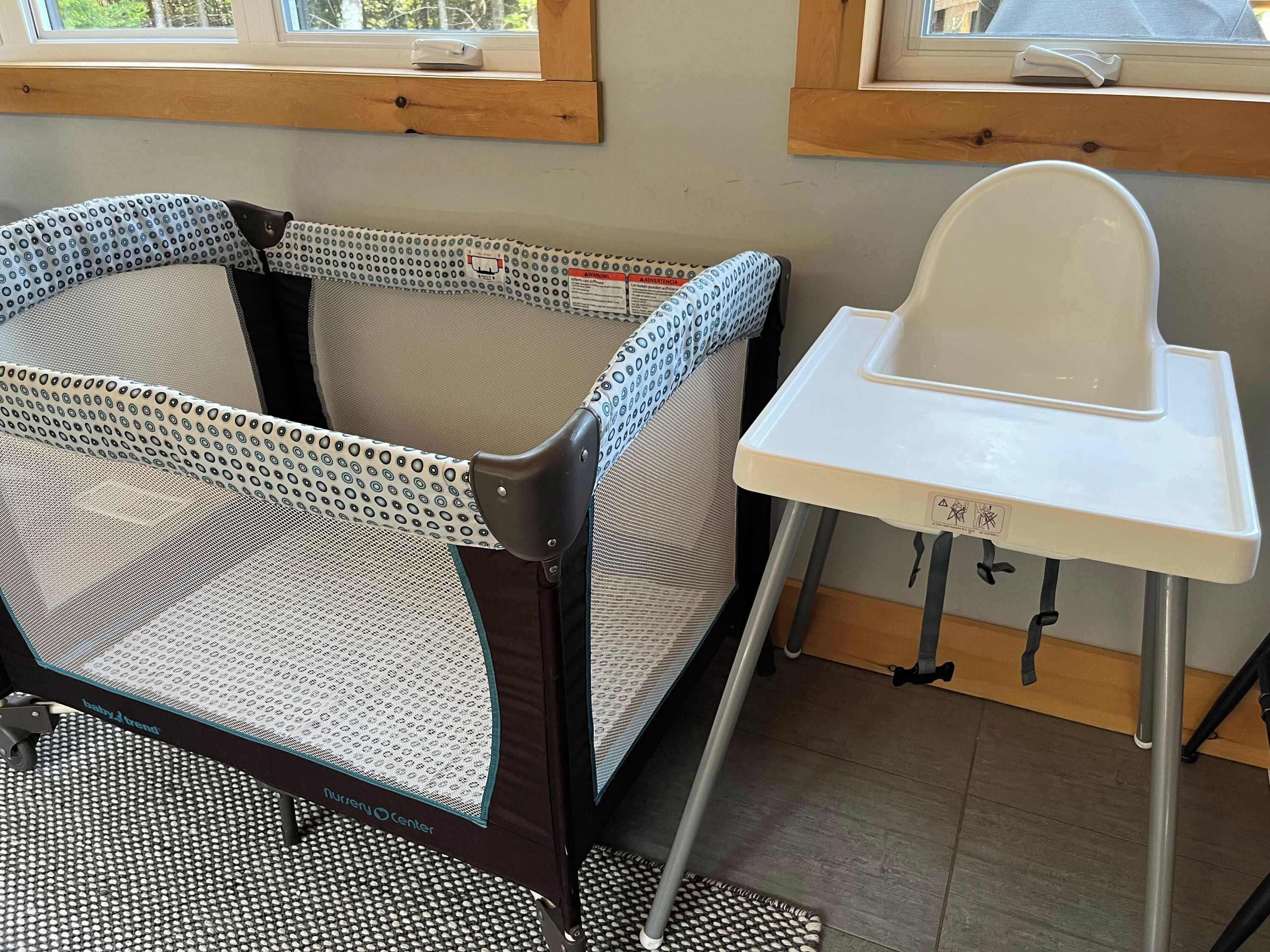 A baby changing station with a high chair and a changing table.