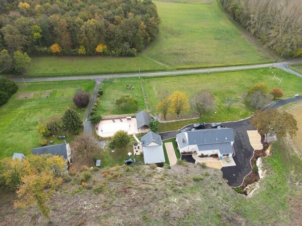 A residential area with a house, a driveway, and a road.