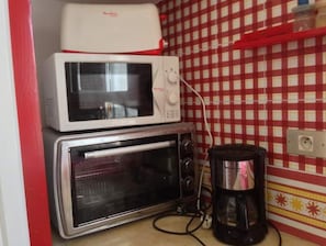 Kitchenette features a microwave oven, toaster oven, and coffee maker.