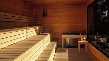 A sauna with wooden benches and a table with bowls.