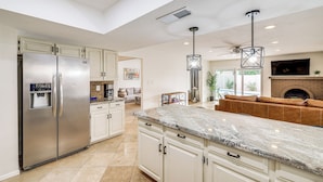 A spacious kitchen with a large island, stainless steel appliances, and a fireplace. - 6 Mi to TPC Scottsdale: Family Escape w/ Fire Pit! (Scottsdale)
