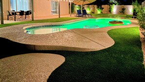 A backyard with a swimming pool, a patio table, and two lounge chairs. - 6 Mi to TPC Scottsdale: Family Escape w/ Fire Pit! (Scottsdale)