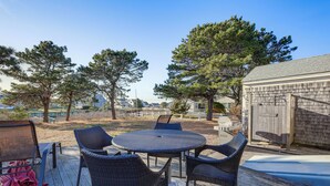 A deck with wicker furniture and a barbecue grill. - Private Dock: Fisherman's Paradise on Bass River (West Dennis)