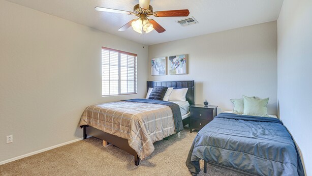 A bedroom with two beds, a ceiling fan, a window, and artwork on the wall. - Spacious Phoenix Vacation Rental w/ Private Pool! (Phoenix)