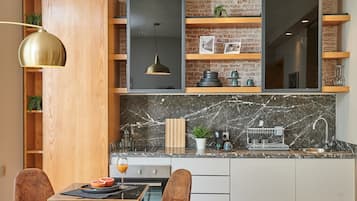 Deluxe Duplex | Private kitchenette | Full-size fridge, cookware/dishes/utensils, cleaning supplies