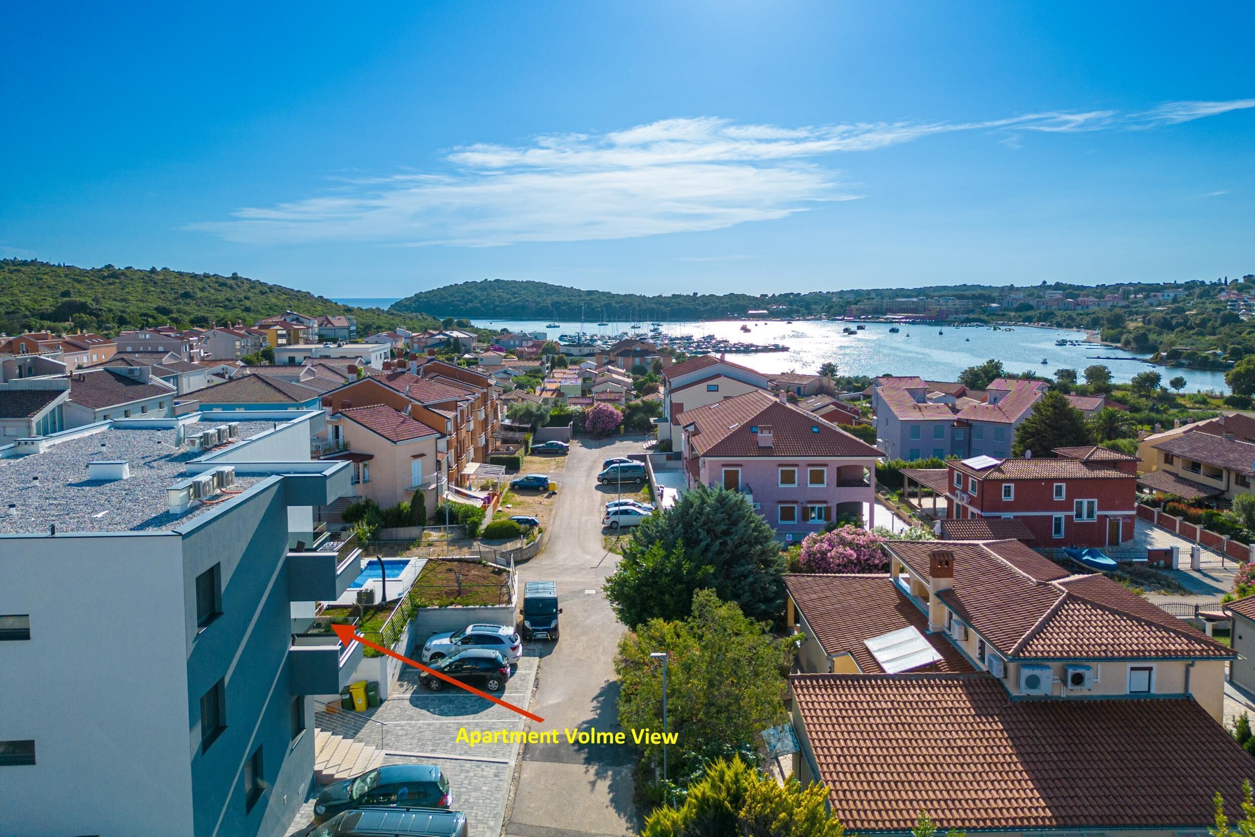 A residential area with a view of a body of water and boats.