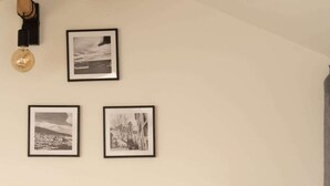 A bedroom with a bed, a nightstand, and a wall-mounted lamp. - Apartment Roof Top with spa (Bastia)