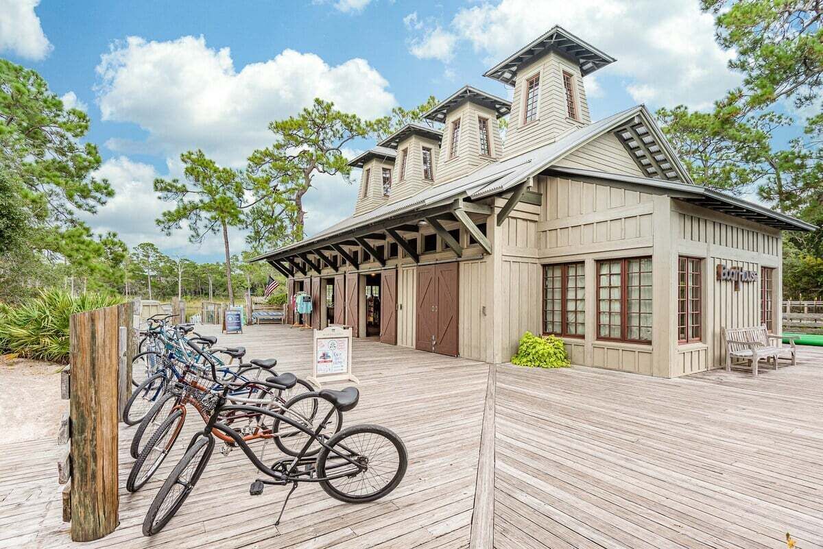 A wooden building with a covered porch and a bike rack outside.