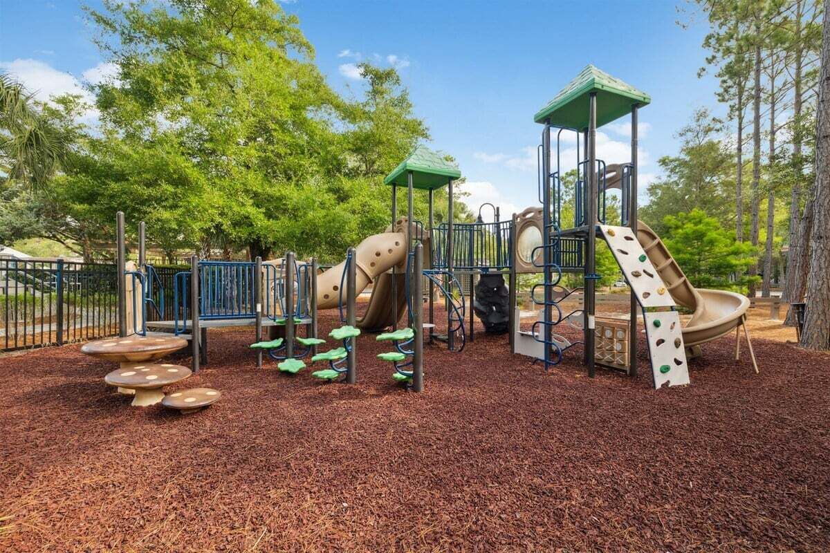 A playground with a slide, climbing structures, and a covered play area.