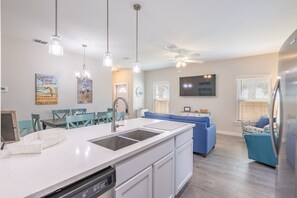 Enjoy cooking in this well-equipped kitchen with a central island, sink, and dishwasher.