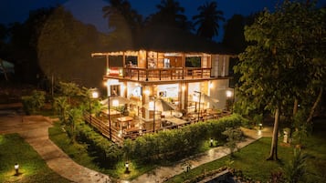 A two-story building with a restaurant on the ground floor and a bar/lounge area on the upper level.