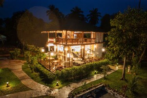 A two-story building with a restaurant on the ground floor and a bar/lounge area on the upper level.