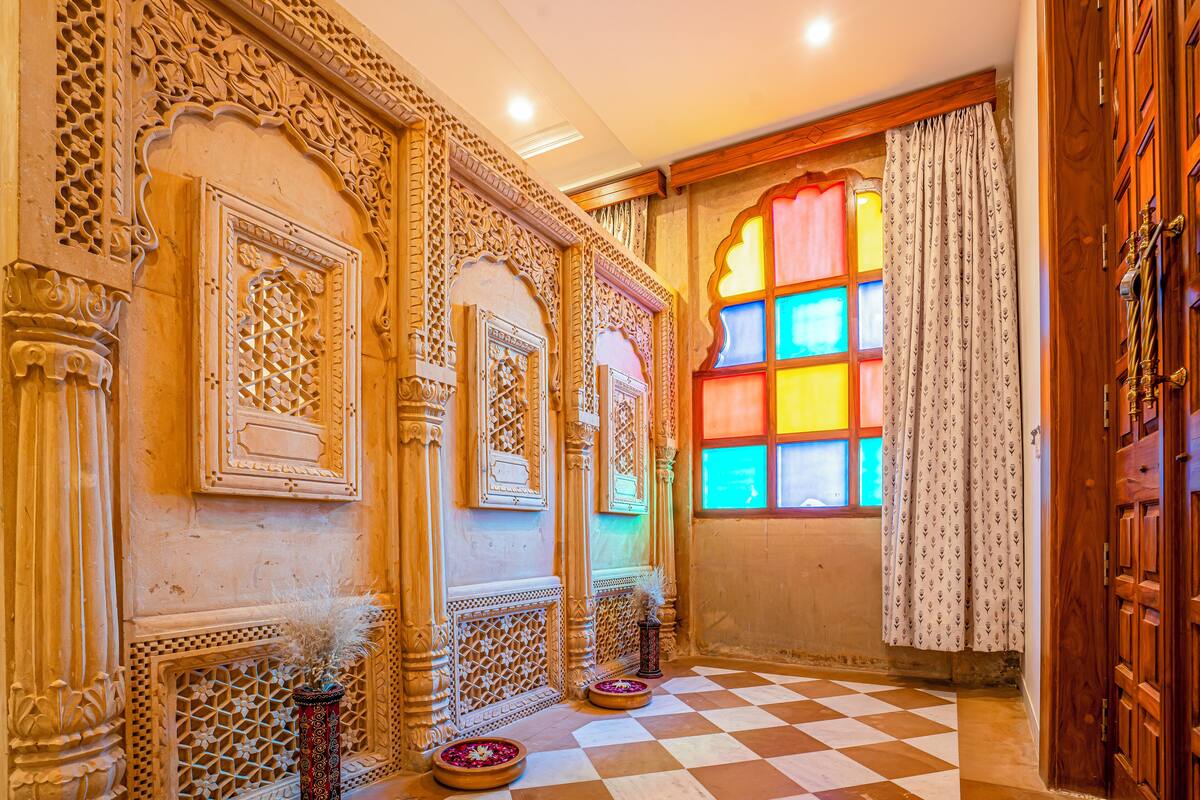 An ornate room with intricate carvings, a checkered floor, and a window with colorful stained glass.