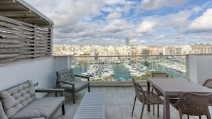 A balcony with a view of a marina and cityscape. - Beautiful seafront home with private balcony & BBQ (Tal-Pietà)