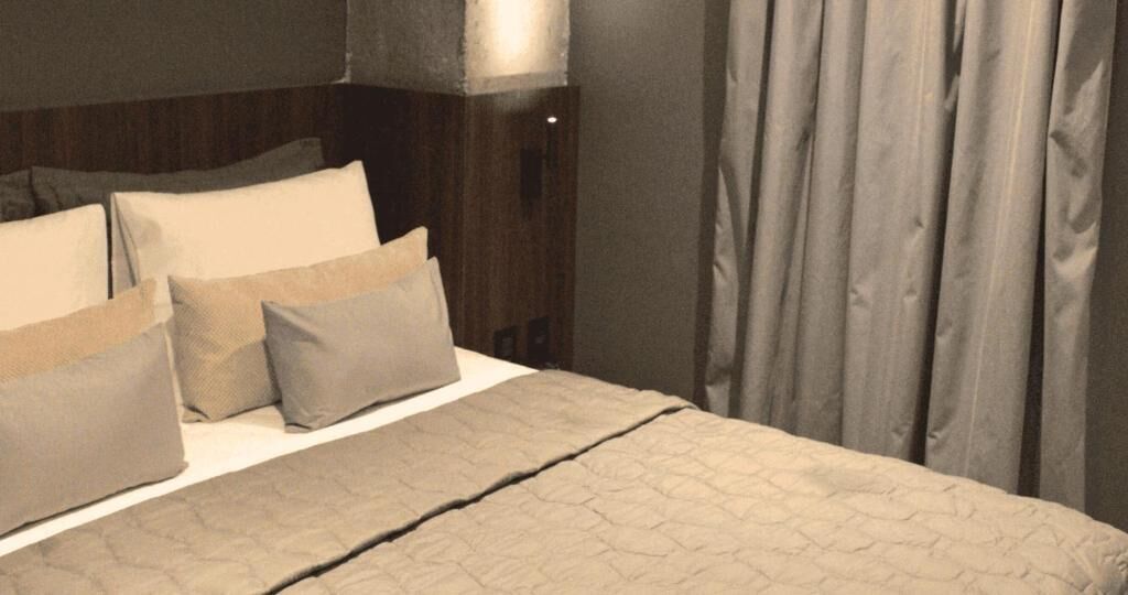 Laptop workspace, bed sheets