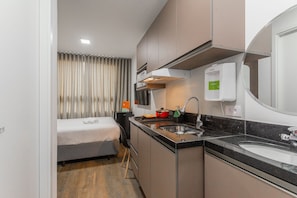 Studio | Private kitchen | Fridge, microwave, cookware/dishes/utensils, dining tables