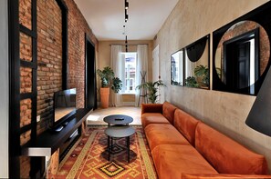 Suite Grand | Zona de estar | Una televisión de pantalla plana