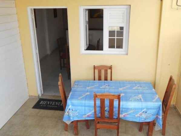 Enjoy meals in this cozy dining area with a table for four, surrounded by a nautical-themed tablecloth and comfortable seating.