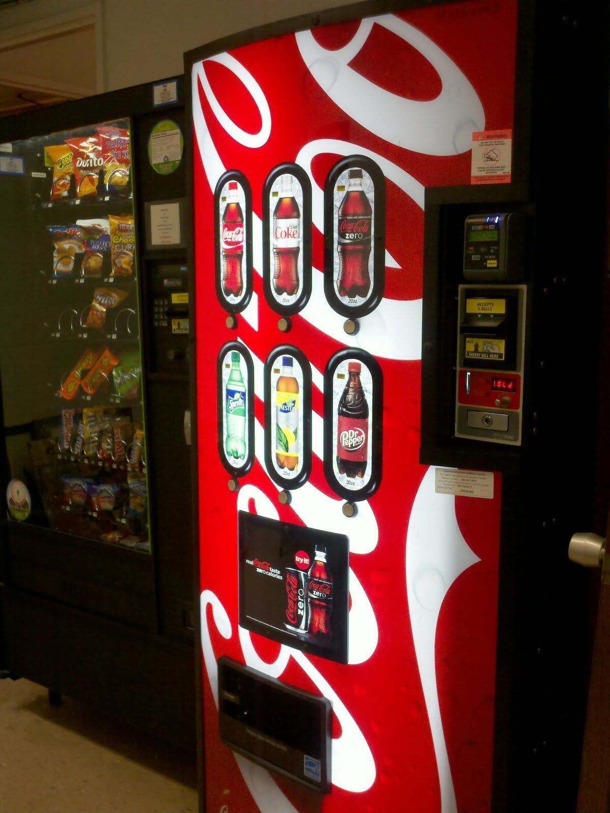 A vending machine with various beverage options, including Coca-Cola and Sprite, and a digital payment terminal.
