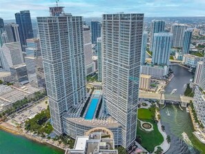 A high-rise building complex with multiple skyscrapers, a central swimming pool, and a river running through the area. - 28th Floor Icon Brickell Oasis with City Views (Miami)