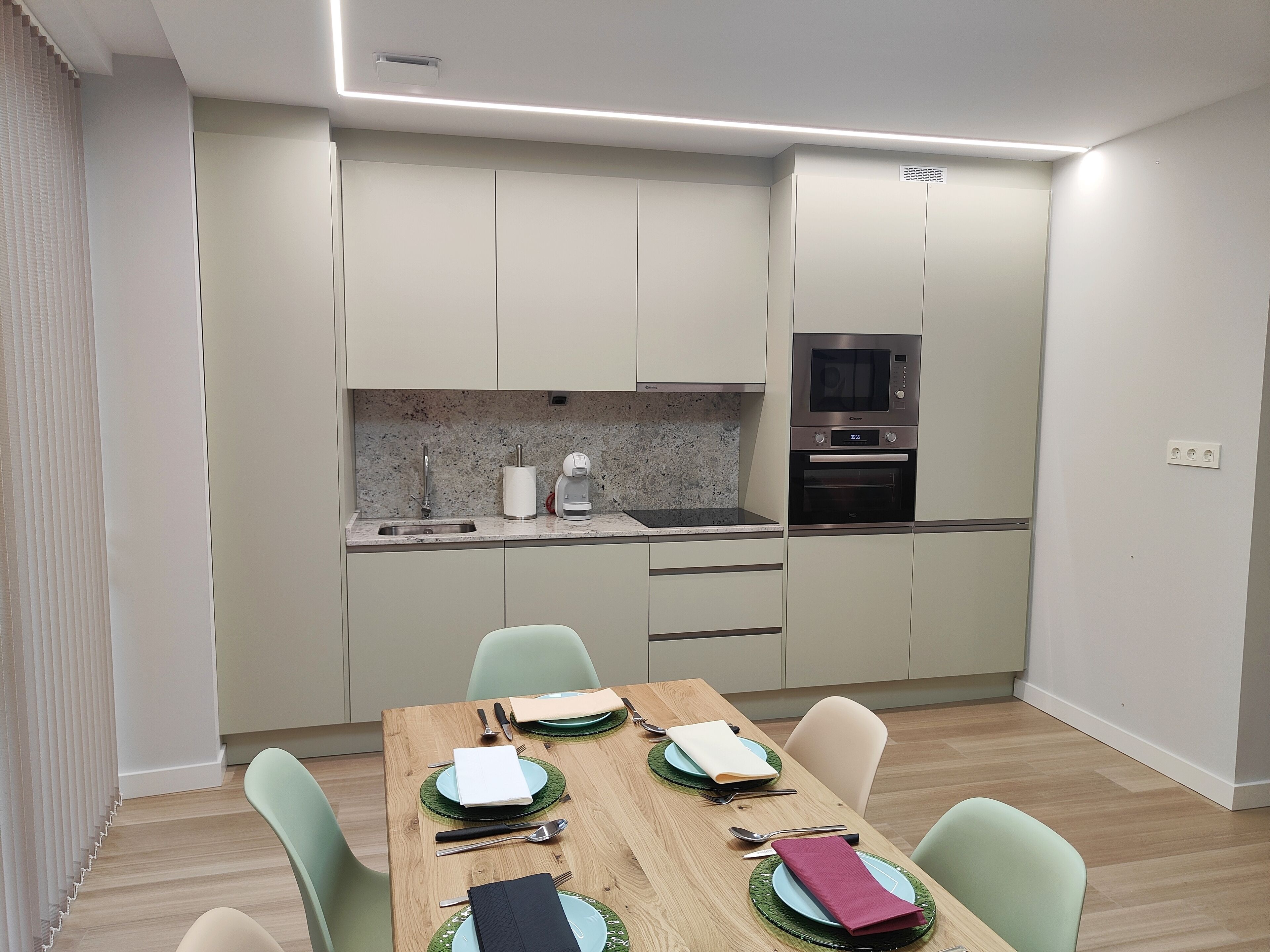 A modern kitchen with a dining area.