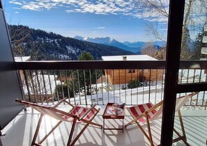 Enjoy breathtaking views of the surrounding mountains from this balcony.