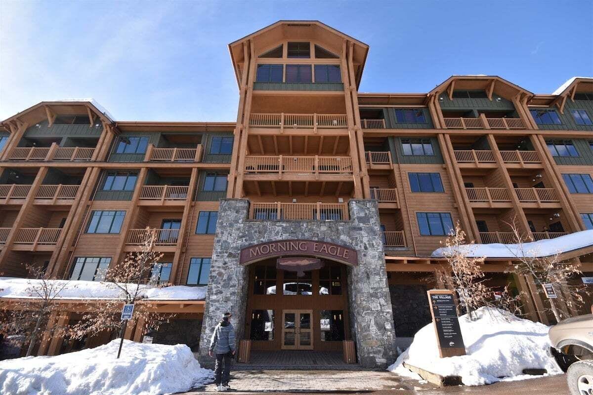 A multi-story hotel with a stone facade and wooden balconies.