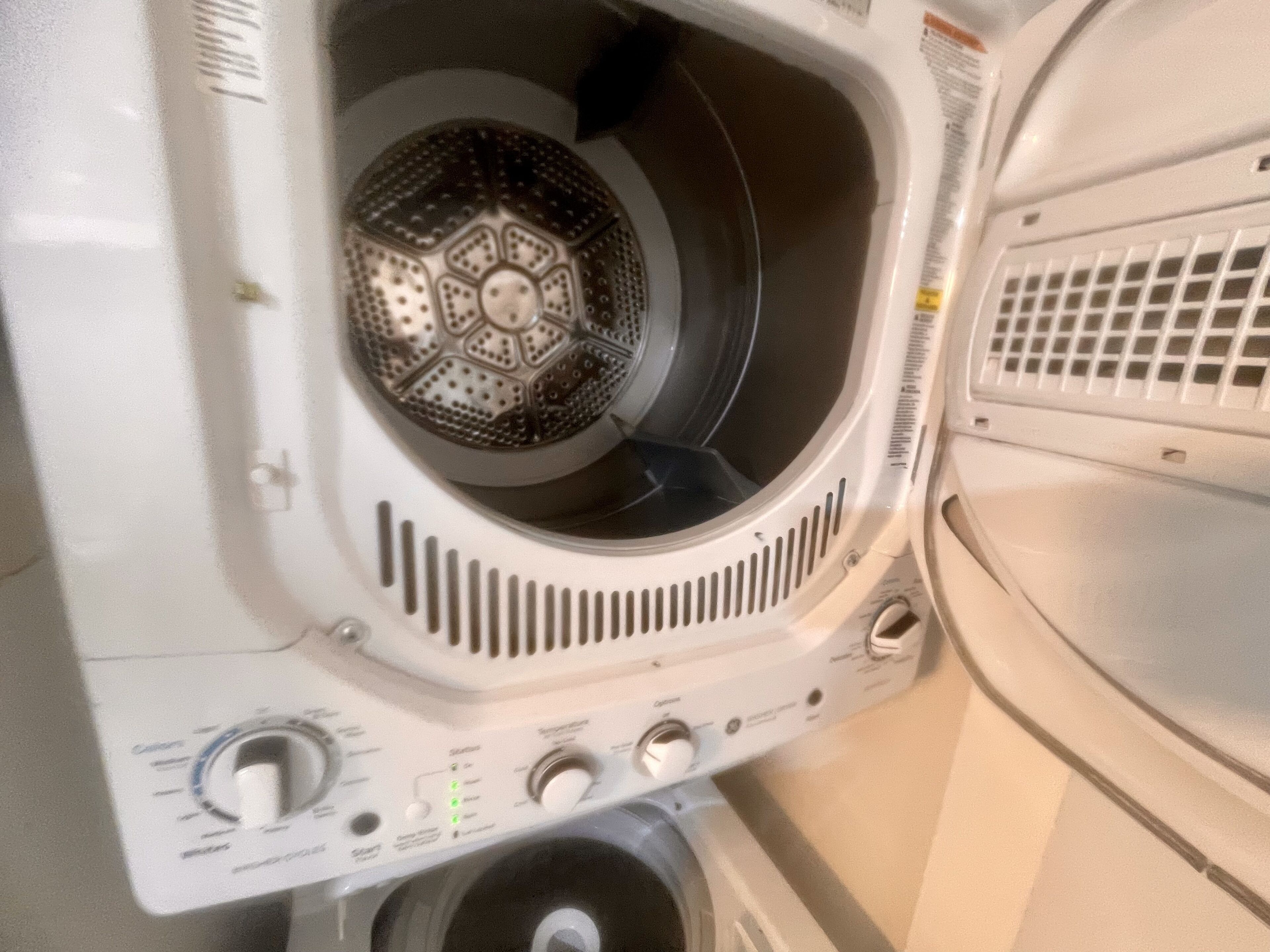 A white washing machine with a control panel featuring multiple dials and buttons.