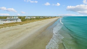 A beach with houses along the shore.
