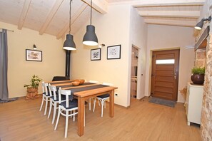 Enjoy meals in this inviting dining area with a wooden table and comfortable seating.