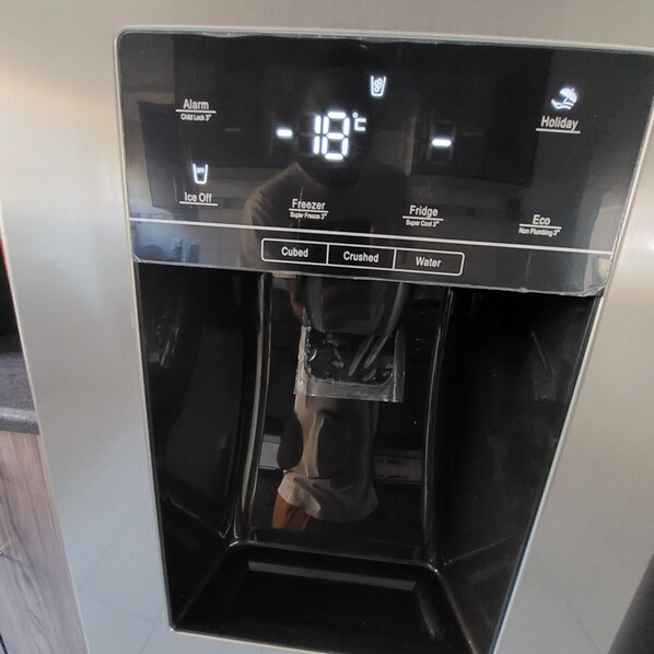 A digital water dispenser with temperature settings, ice options, and a cubed water button. - A staycation in walvis bay
(walvis bay)