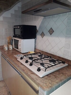 Fridge, microwave, coffee/tea maker, cookware/dishes/utensils