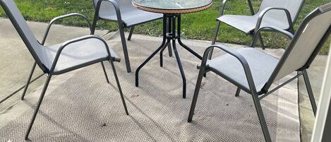 A patio with a round table and four chairs.