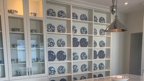 A kitchen with white cabinetry, a marble countertop, and a display of blue and white patterned plates. - In Town Beautiful Trim Castle Cottage   (Trim)
