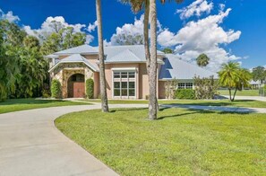 A single-story house with a front entrance, a garage, and a well-maintained lawn.