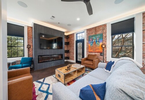 Chic Downtown Retreat | Fireplace | Game Area