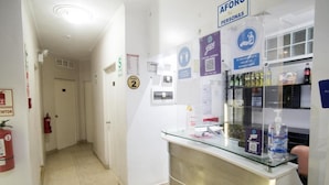 A reception area with a glass counter, a fire extinguisher, and a sign indicating room number 2. - hospedaje sueños (Lima)