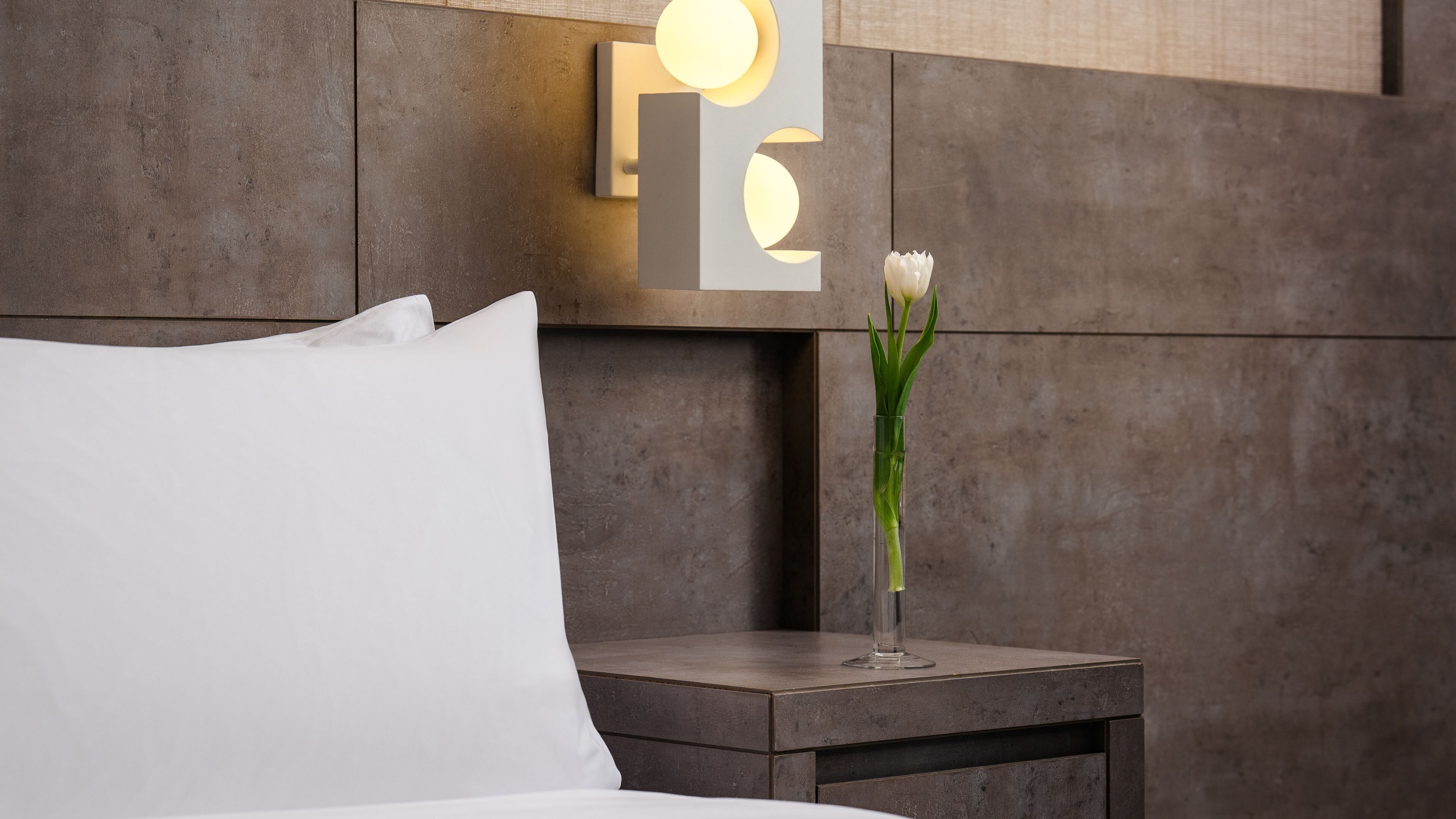 Premium bedding, desk, laptop workspace, blackout drapes