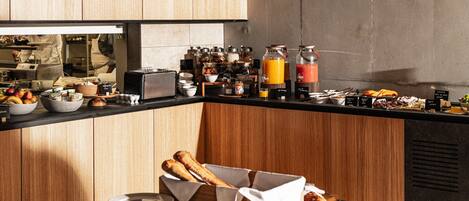 A breakfast buffet with various food items and beverages.