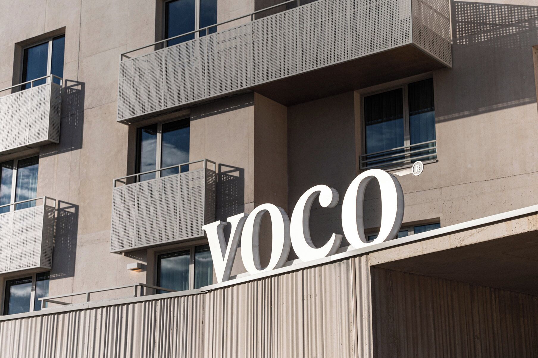 A building with the sign "VOCO" indicating a commercial property.