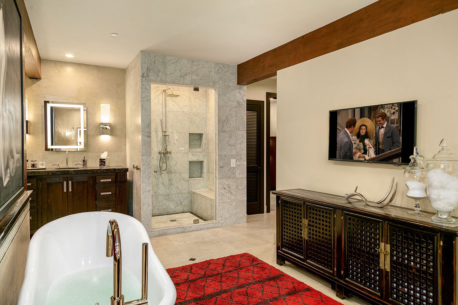 A modern bathroom with a freestanding bathtub, a walk-in shower, and a vanity with a mirror.