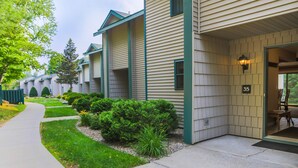 A multi-story building with a covered entrance, a number '35' sign, and a pathway leading to the entrance. - Cascade Lodge u31 - Short Walk to Main Street! (Lake Placid)