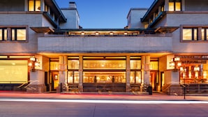 A hotel with a modern architectural design, featuring a prominent entrance with steps and a glass facade. - The Historic Park Inn Hotel (Mason City)