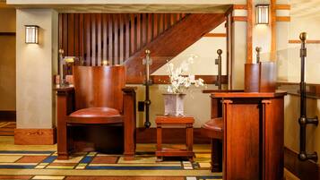 Welcome to our traditional lobby, featuring a reception desk, comfortable seating, and a beautiful vase of flowers.