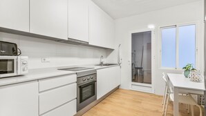 A modern kitchen with white cabinets, a stainless steel oven, and a microwave. - Apartment 'Moriones Playa' with Balcony, Wi-Fi and Air Conditioning (Torrevieja)