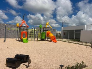 A playground with slides and climbing structures.