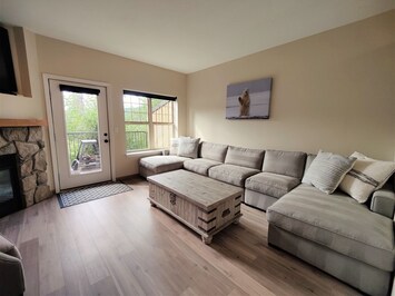 Bright Living Room with Hidden Storage and Gas Fireplace